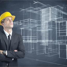man in suit and hard hat looking up with a blueprint design in background