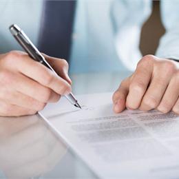 man signing a terms and conditions piece of paper