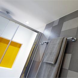 GRP hybrid bathroom pods with tiled inset wall